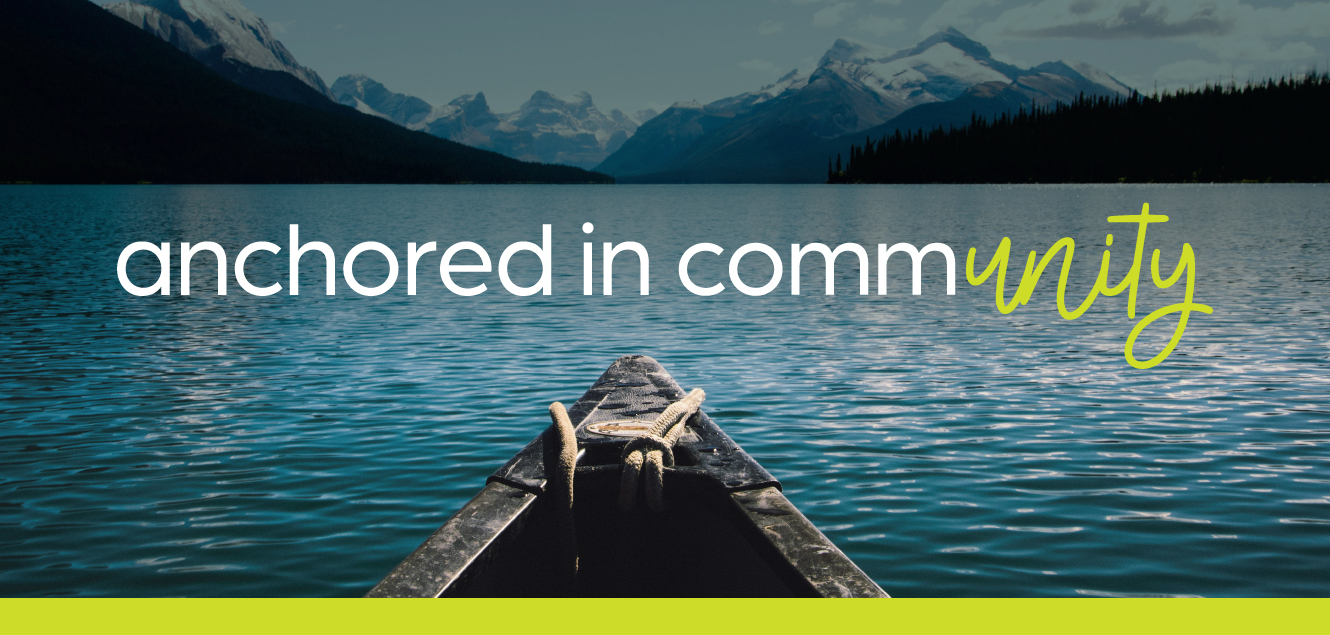 front of a boat floating in a mountain lake reading anchored in community